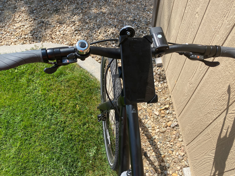 Handlebar set up for bicycle commuting including cell phone holder, light, bell and reflector